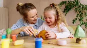 lady playing with colorful blocks with a little girl