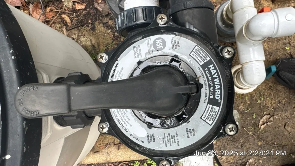 Top-down close-up of a Hayward Vari-Flo valve handle on a pool filter during a service call in Lakehurst, NJ by Gorlin Pools