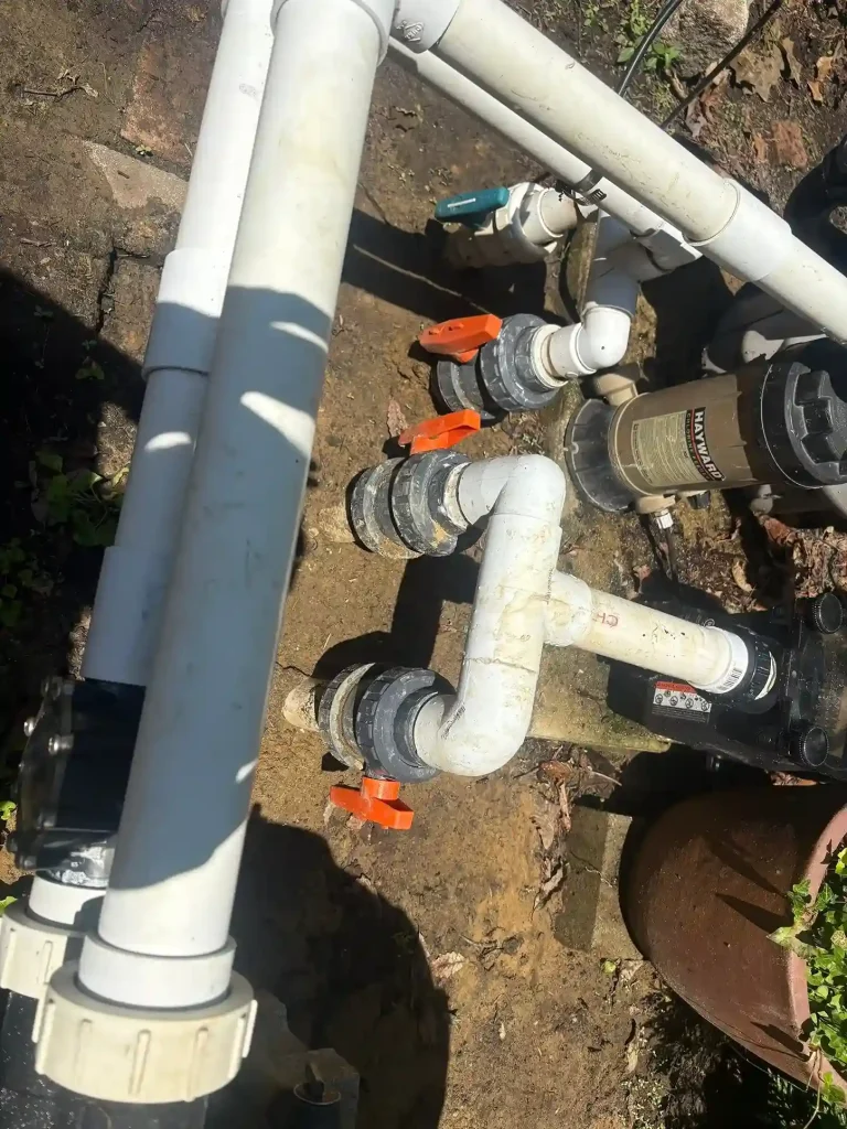 Pool PVC plumbing pipes, ball valves, and Hayward pump during equipment service and repair in Lakehurst, NJ by Gorlin Pools
