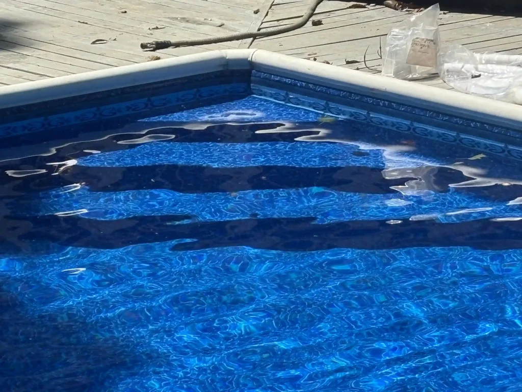 Close-up of pool entry steps with a newly installed patterned vinyl liner being filled with water in New Jersey by Gorlin Pools