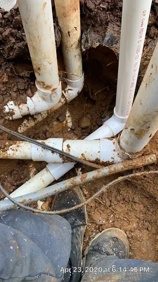 Excavated underground PVC pipe network exposed during pool leak detection and repair in Lakehurst, NJ by Gorlin Pools