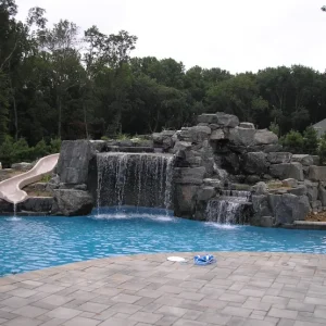completed-granite-grotto-waterfall-slide-freeform-pool-paver-deck-lakehurst-nj-gorlin-pools
