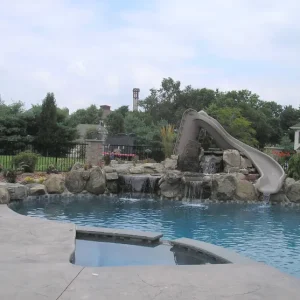 freeform-pool-gray-grotto-slide-rock-waterfall-iron-fence-suburban-lakehurst-nj-gorlin-pools