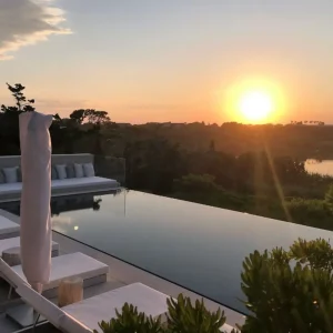 pelican pools - infinity pool on sunset