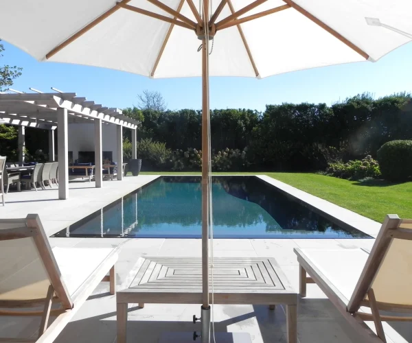 Pergola and shaded seating area near pool
