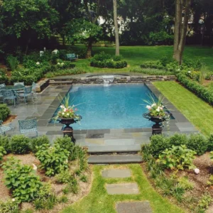 rectangular-pool-bluestone-deck-stone-wall-waterfall-urn-planters-formal-garden-lakehurst-nj-gorlin-pools